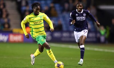 Jonathan Rowe dribbles past a defender in a Norwich City match, showcasing his agility and skill.