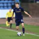 Owen Beck playing for Dundee, showcasing his skills on the left wing.