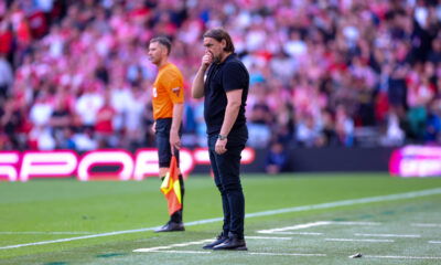 Daniel Farke in a thoughtful pose during a Leeds United match, reflecting the challenges of club management.
