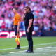 Daniel Farke in a thoughtful pose during a Leeds United match, reflecting the challenges of club management.