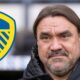 Leeds United manager Daniel Farke next to a Leeds badge